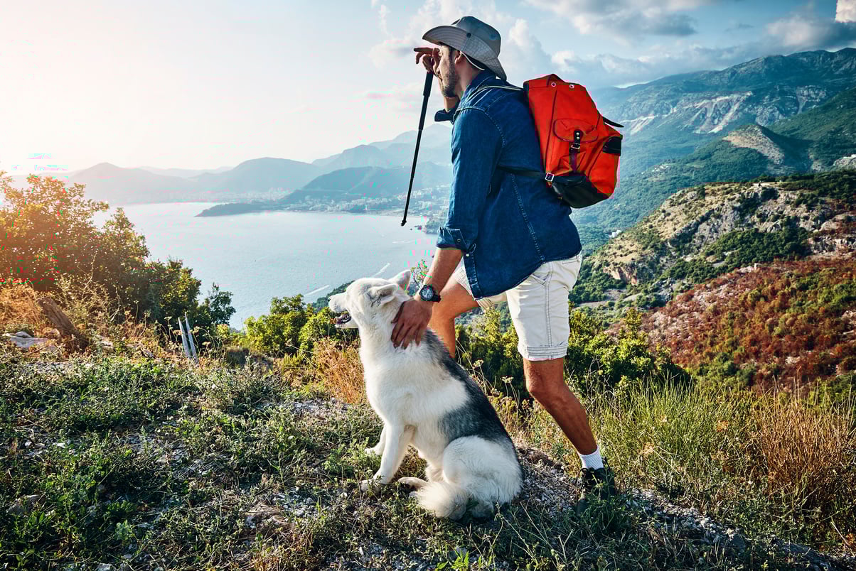man hiking with his dog